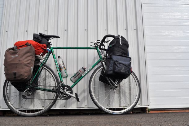 Chris Lee's bike loaded with supplies and leaning against a wall, ready for his cross-Canada journey.
