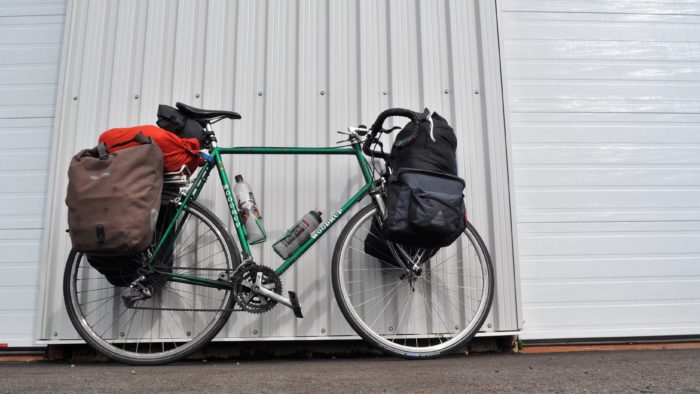 Chris Lee's bike loaded with supplies and leaning against a wall, ready for his cross-Canada journey.