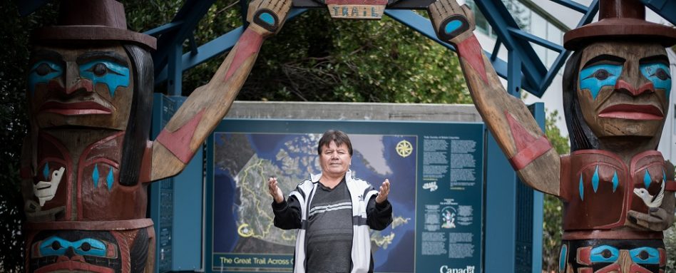 Darren Yelton standing in front of a Trans Canada Trail map sign