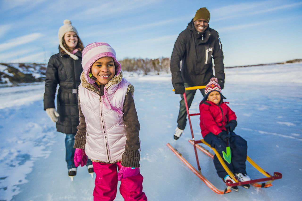 Family with children walking on frozen lake