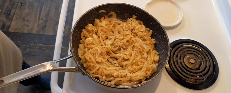 A skillet on a stove top with crockpot respire ingredients 