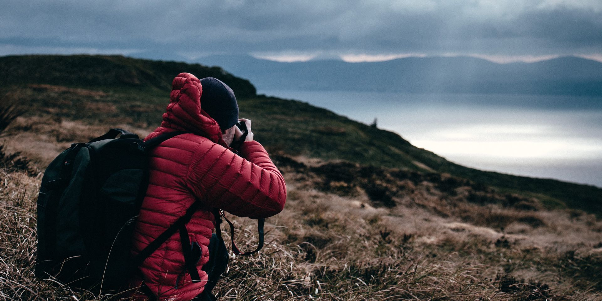 An adult taking a photo of a landscape. This image is an example for the Trans Canada Trail photo contest