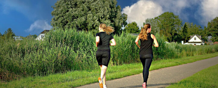 An image of two adults trail running