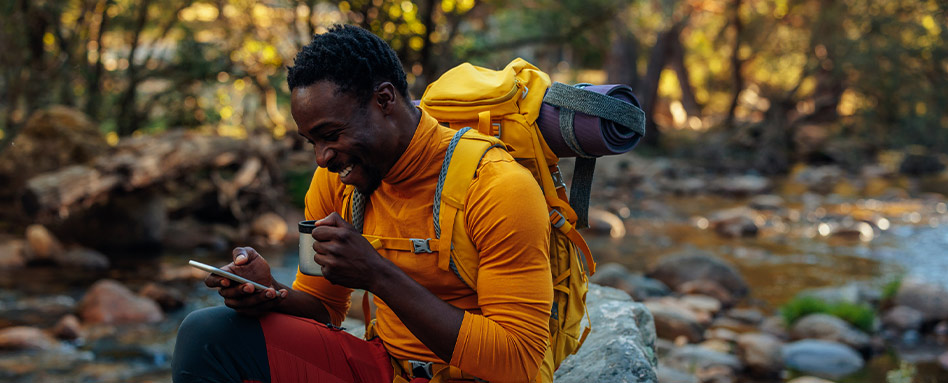 A person outside looking at the Trans Canada Trail map on their phone