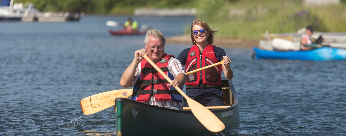 Valerie Pringle and a man paddling a canoe on a water trail