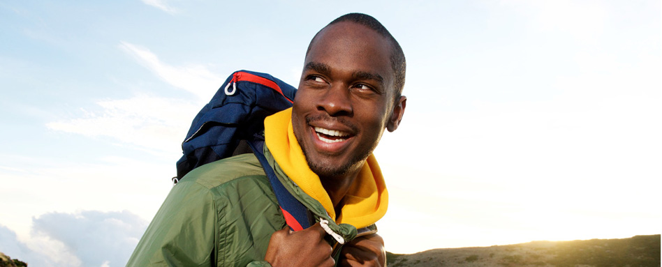 A male hiker wearing a hiking backpack