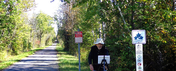 David Kearn painting outside on the trail