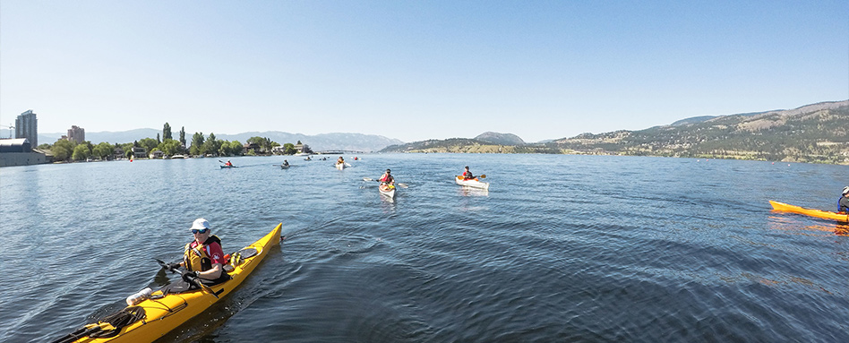 Trail tourism: multiple people in kayaks on the water 