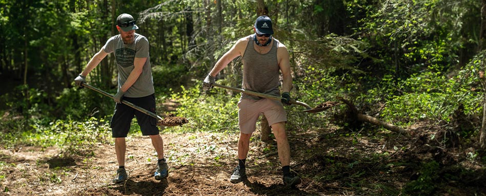 Two volunteers cleaning up debris at the Kimberley Trail Society Trail Care Event