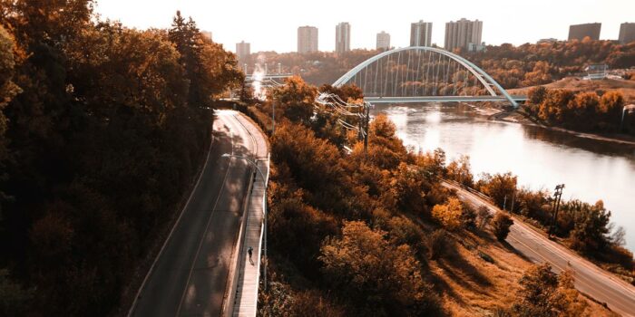The cover photo of Trans Canada Trail's imapct report. It shows a person running a boardwalk along the North Saskatchewan River in Edmonton, Alberta