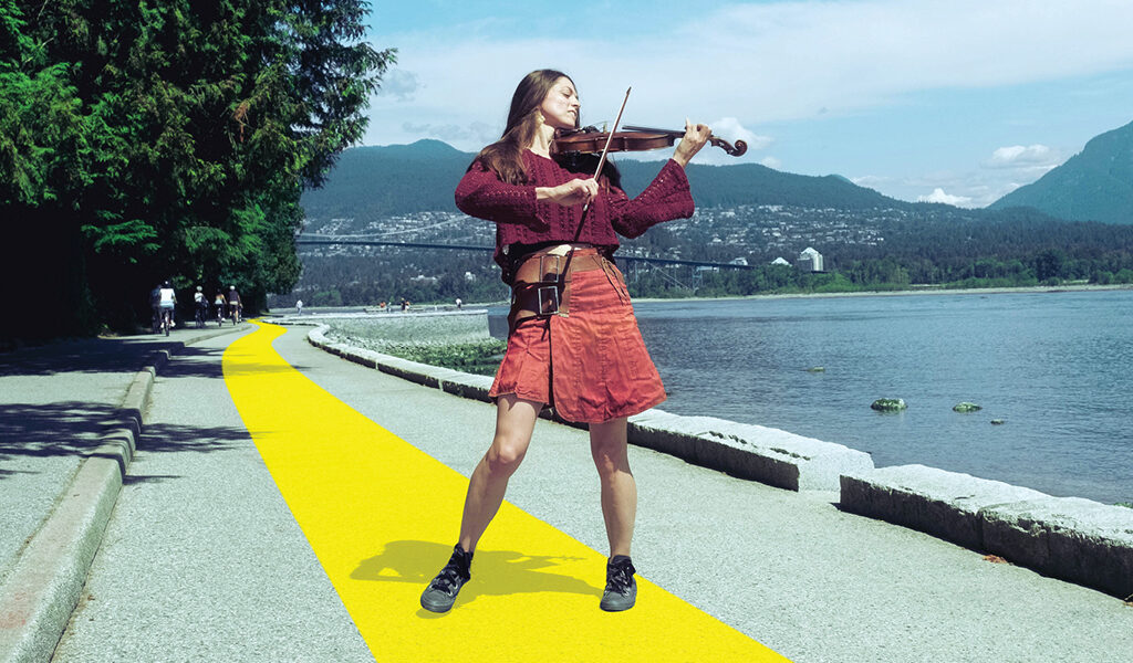 A woman standing on a yellow line on the Trans Canada Trail playing the violin for the Made To Be On campaign
