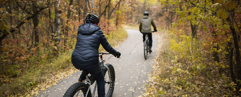 Two adults biking on the Pinawa trail