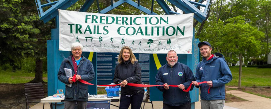 The city of Fredericton supporters cutting a ribbon at the trail