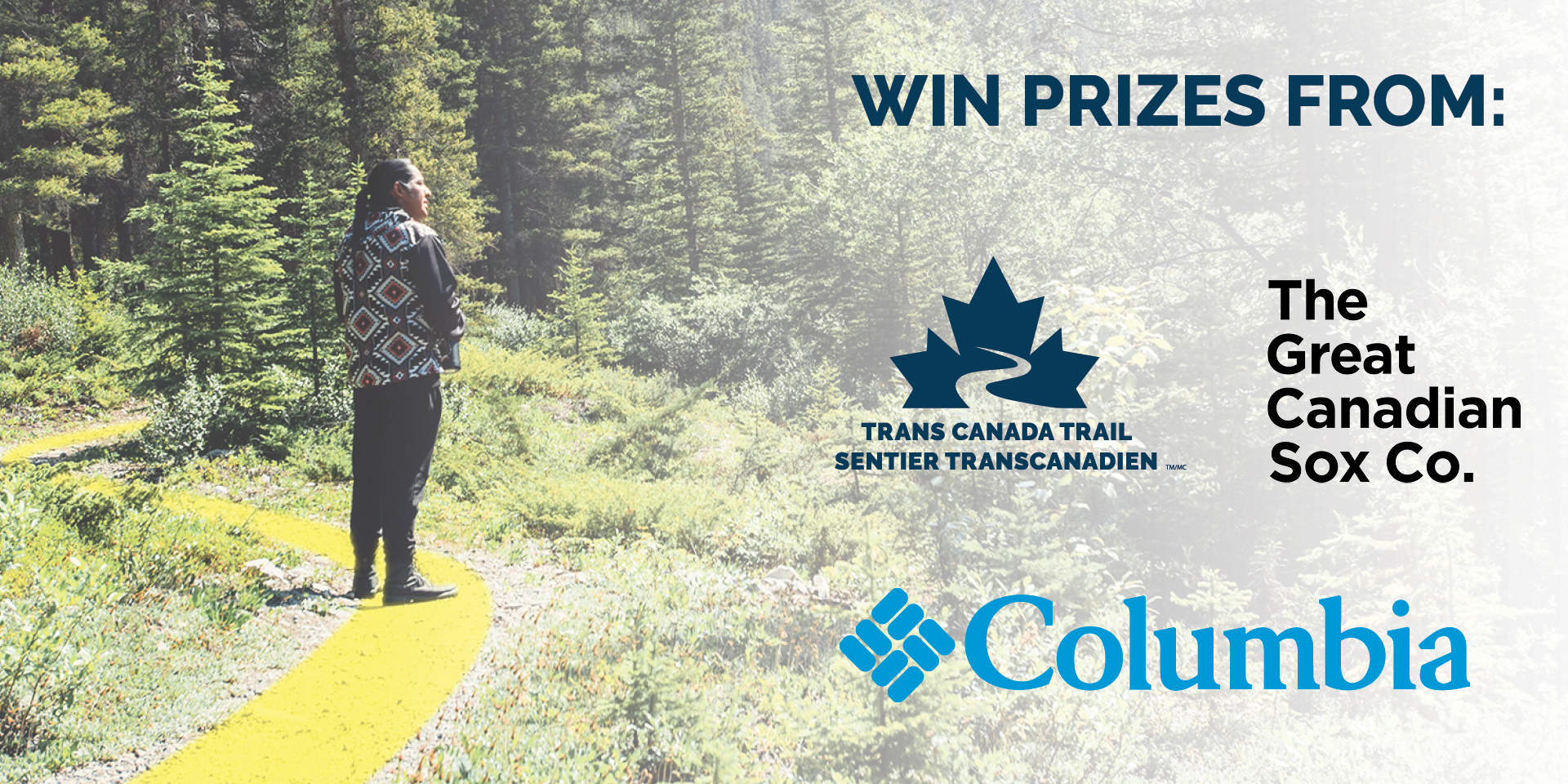 A man standing on the trail surrounded by trees. Image includes the Tranas Canada Trail logo, The Great Canadian Sox Co. logo and the Columbia logo