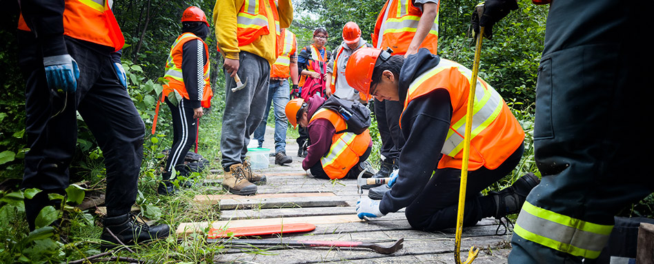 Indigenous high school students working on a trail for the OYEP program