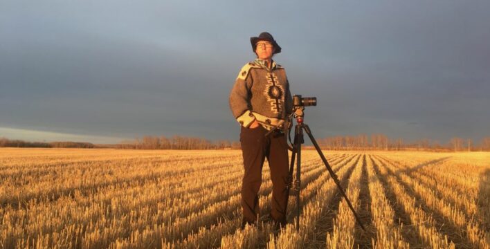 Dianne Whelan in a field with a camera