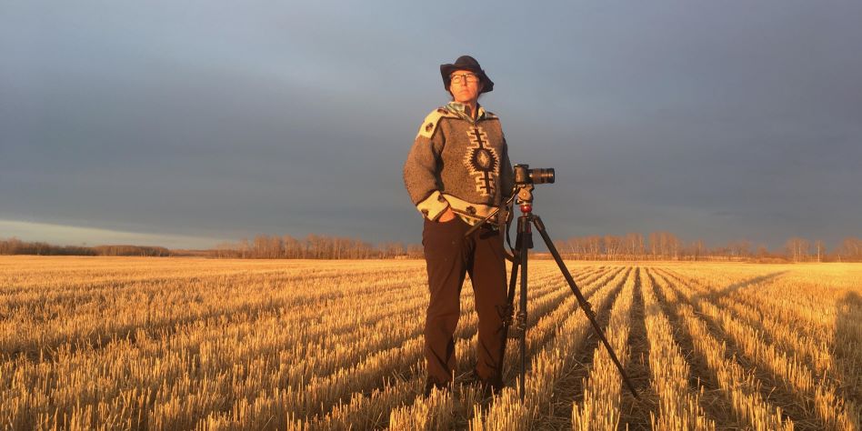 Dianne Whelan in a field with a camera