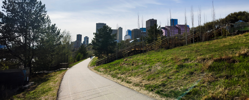 A paved path leading towards a city skyline in the background. | A paved path leading towards a city skyline in the background. 