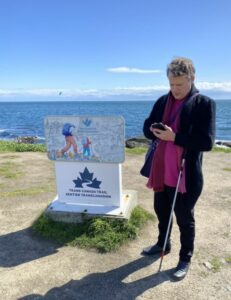 Michael Moore using BlindSquare at the Pacific Ocean Trailhead of the Trans Canada Trail on the City of Victoria Trail.