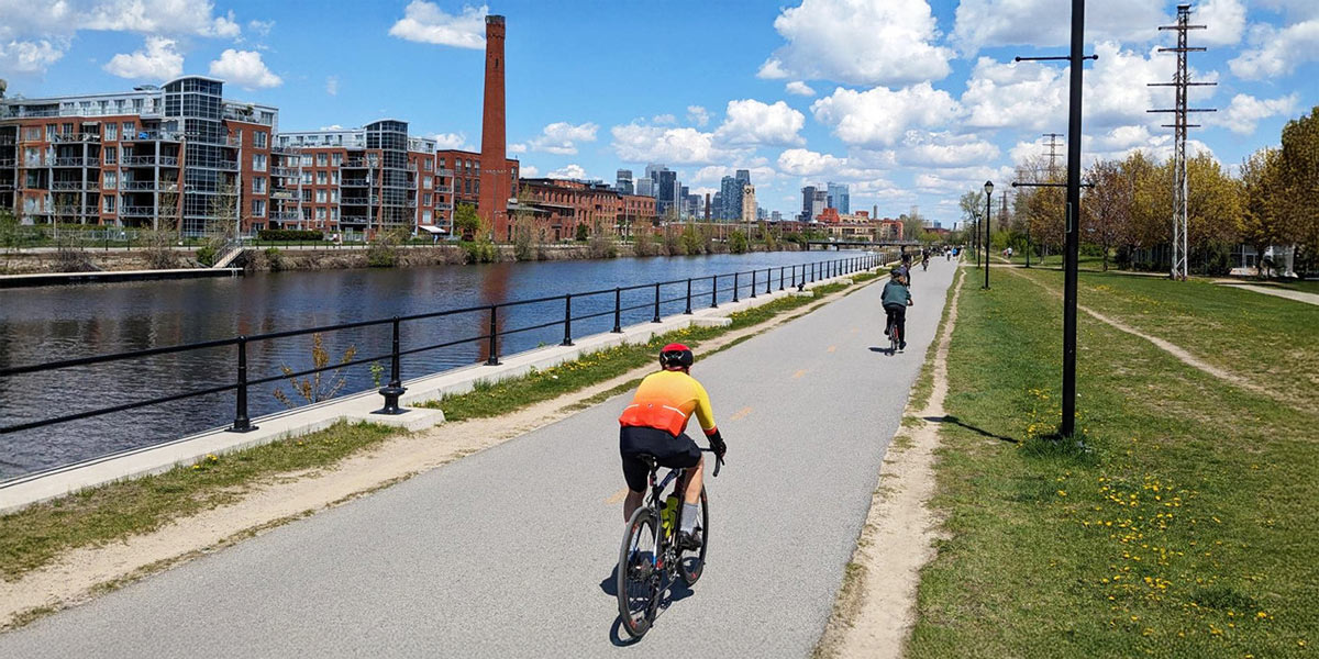 view of people cycling alongside a canal