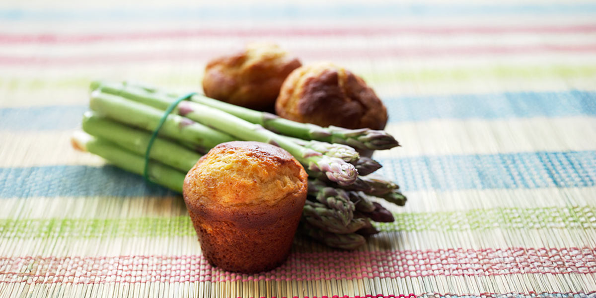 photo of muffins and esparagus on table cloth
