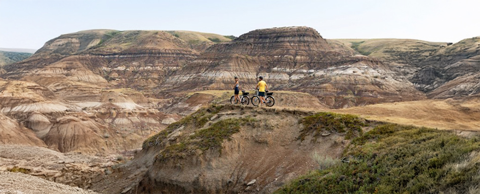 two men with bikes on top of a mountain