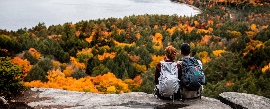 Young couple hiking in mountain and relaxing looking at view