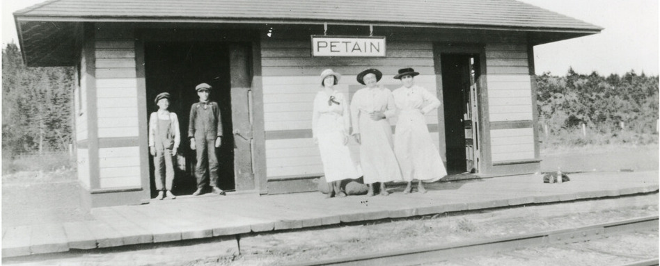 photo of women standing at an old railway