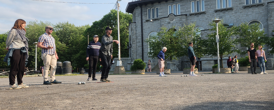 people on a court with buildings behind