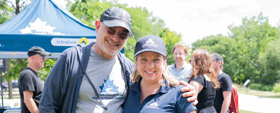 man and woman in Trans Canada Trail branded clothing posing for photo