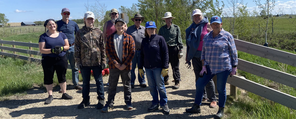 people in tree planting gear posing for a photo on a sunny day