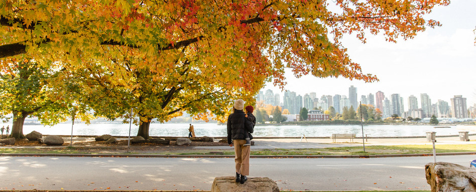 Stanley Park in the fall | Trans Canada Trail woman and baby looking at fall leaves overlooking trees and city