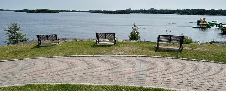 park bench on a trail overlooking body of water