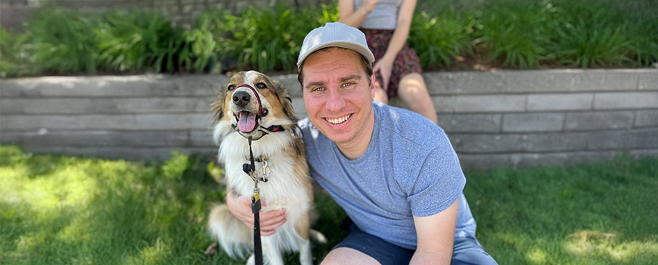 man and dog smiling for a photo