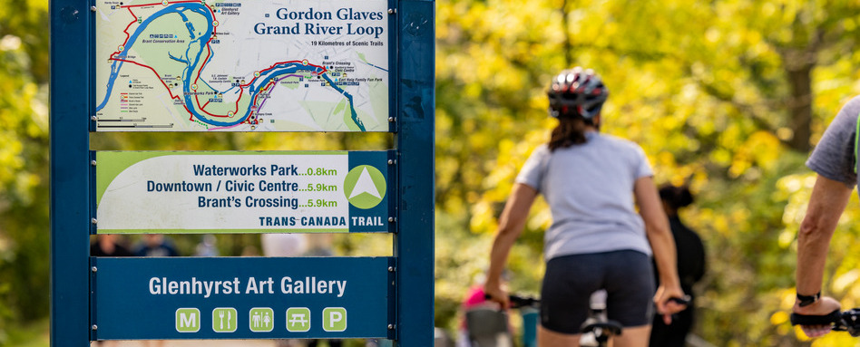 02Support image_ON_Brantford_credit Discover Brantford 1 | Trans Canada Trail person biking on a trail with a marker sign on sunny day