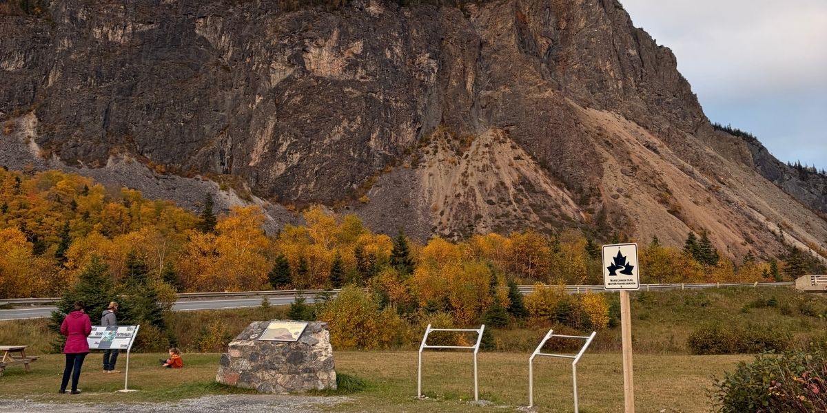 00Feature image_NL_Trail profile Corner Brook_photo credit Ryan Thom | Trans Canada Trail phpto of a mountain with plaque in the foreground during a fall day