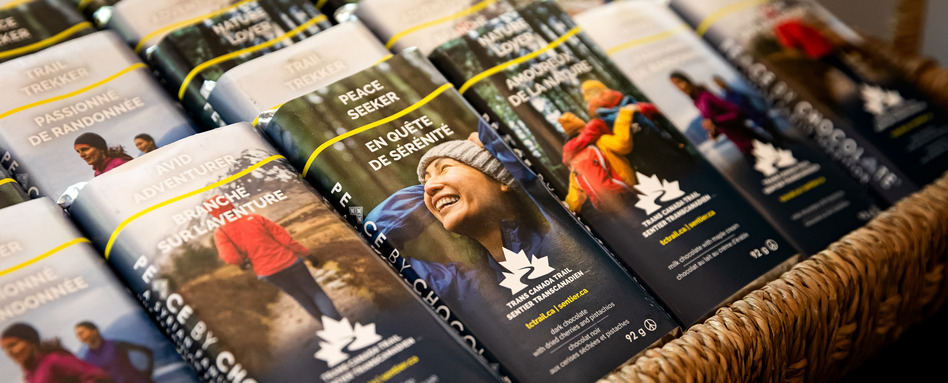 2025-06-05 - Trans Canada Trail - Leigh Peters Event | Trans Canada Trail chocolate bars with people smiling in the outdoors on labels