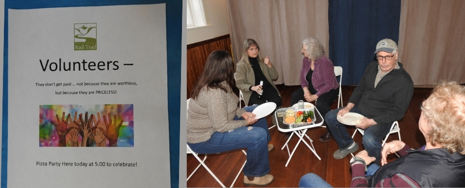group of women sitting around a picnic table inside a wooden house