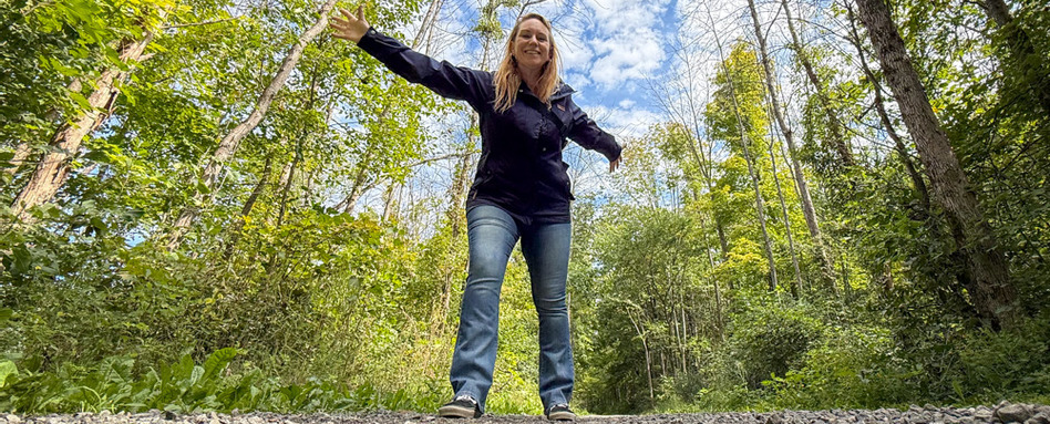 woman posing happily on a trail