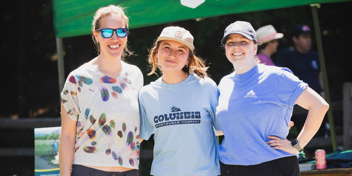 women smiling in tshirts on a sunny day