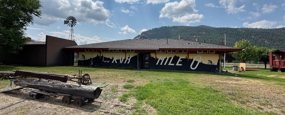 large building in a field with mountain behind