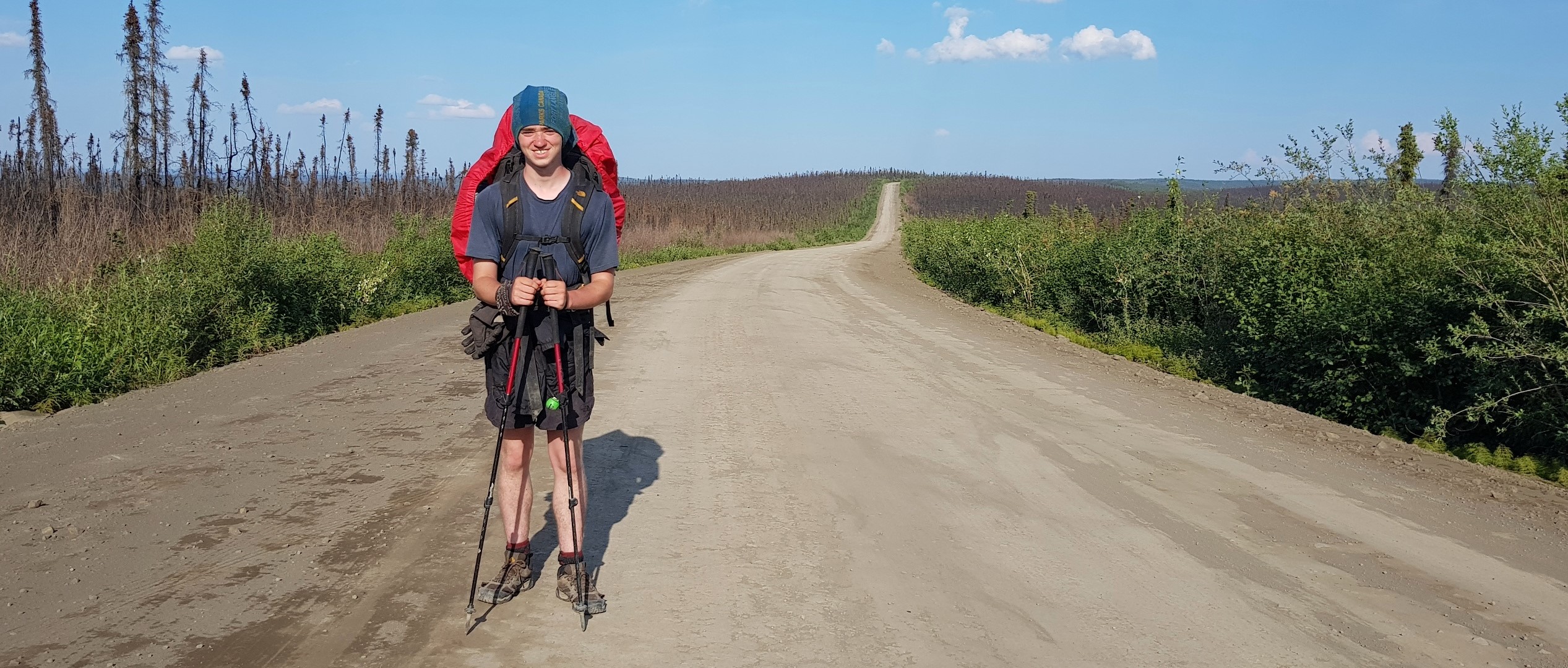 Aidan_Beckett_supportimage_credit-AidanBeckett | Trans Canada Trail Aidan Beckett stops for a photo on a gravel trail.