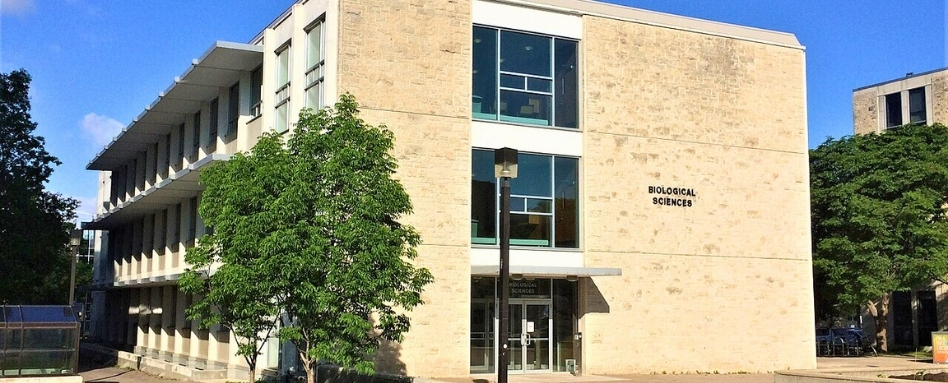03Support image_under Atwell section_credit Jack Coop - former Faculty of Pharmacy bldg U of MB | Sentier Transcanadien A beige brick building that reads Biological Sciences on the side.