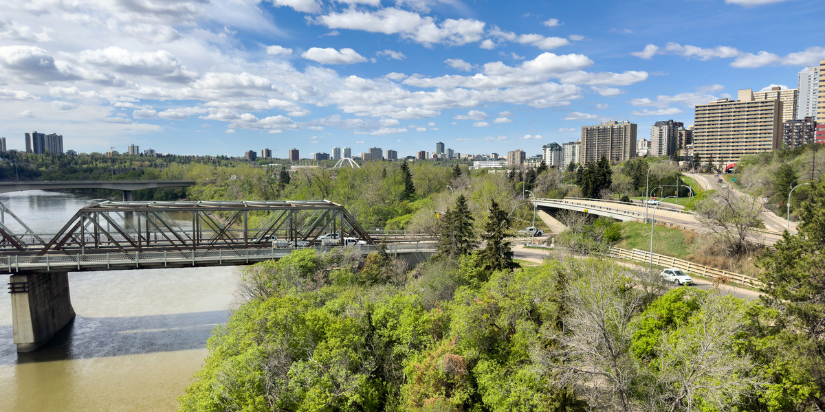 AB - Amisk Wacîw Mêskanaw Beaver Hill Road - City of Edmonton | Trans Canada Trail A city scape including a bridge and a group of green, leafy trees in the foreground