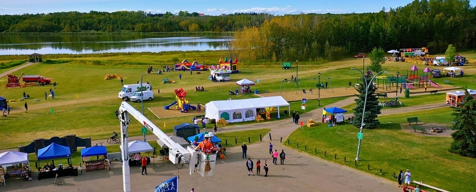 carnival games on a large lawn overlooking lake on a sunny day