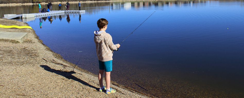 child sihing on a lake