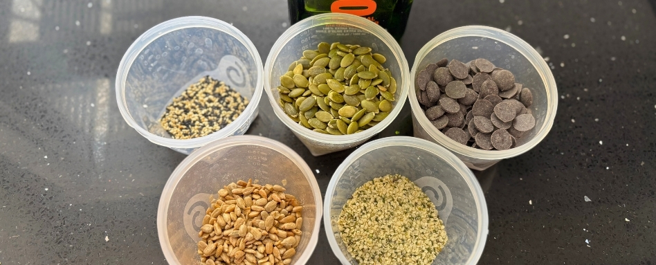 seeds and chocolate in cups on counter
