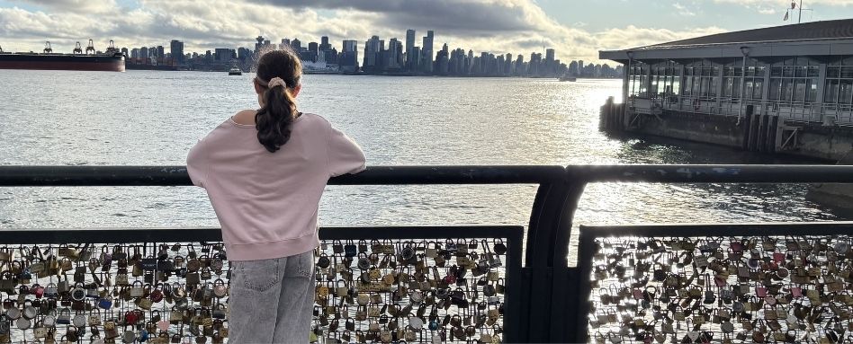 02Support image_Web story_Vancouver Translink SeaBus_credit Amy Schwartz | Trans Canada Trail girl standing on lock bridge overlooking skyline and water