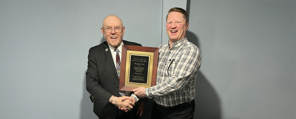 two men shaking hands and laughing