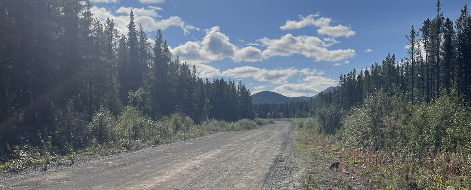 dirt road leading to sunny mountain